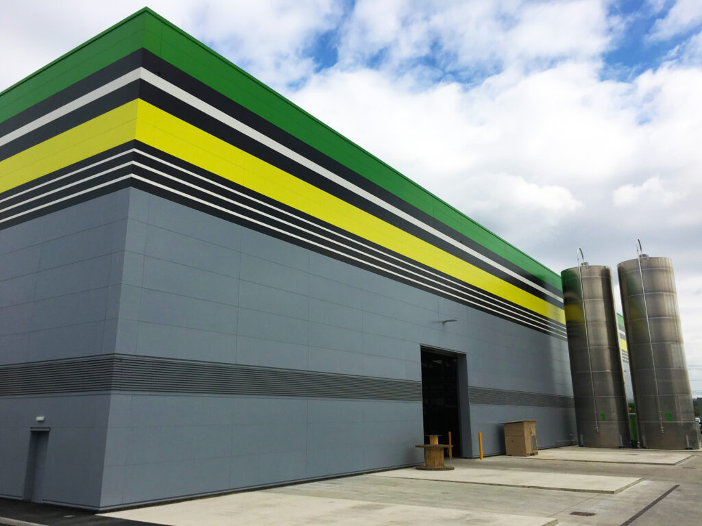 Outside image of the Really Useful Box Company building, with bright green and yellow powder coated trim